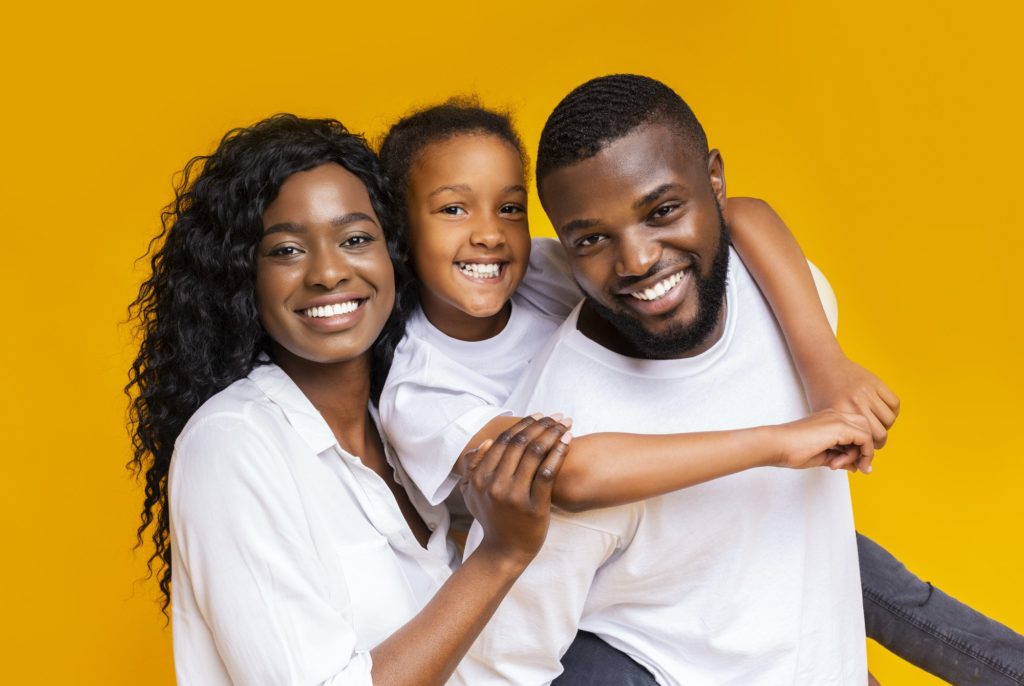 Portrait of positive black family of three