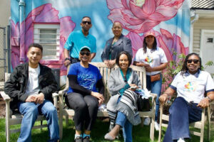 Mercy Center’s Veronica Gilbert-Tyson (bottom right) welcomes representatives from the faith-based community to the nonprofit’s event to commemorate sexual assault awareness and child abuse prevention. 